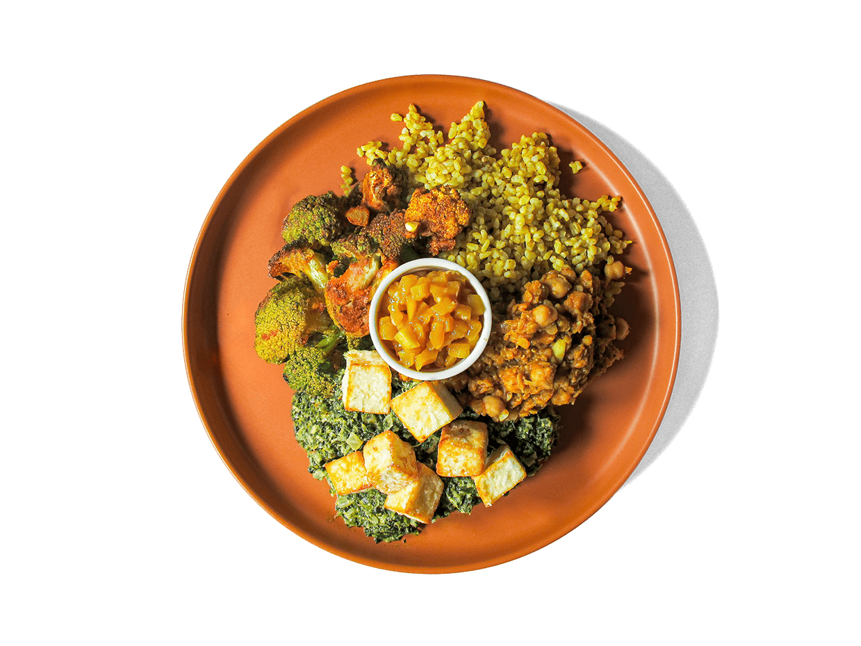 Creamy spinach (saag) simmered with fragrant spices embraces avocado oil-fried cubes of paneer for a comforting, protein-rich centerpiece. It’s paired with hearty chana dal, spice-roasted vegetables, vibrant turmeric rice, and sweet-tangy mango chutney. Bursting with plant-powered protein, fiber, and anti-inflammatory spices, this colorful dish satisfies both taste and well-being.