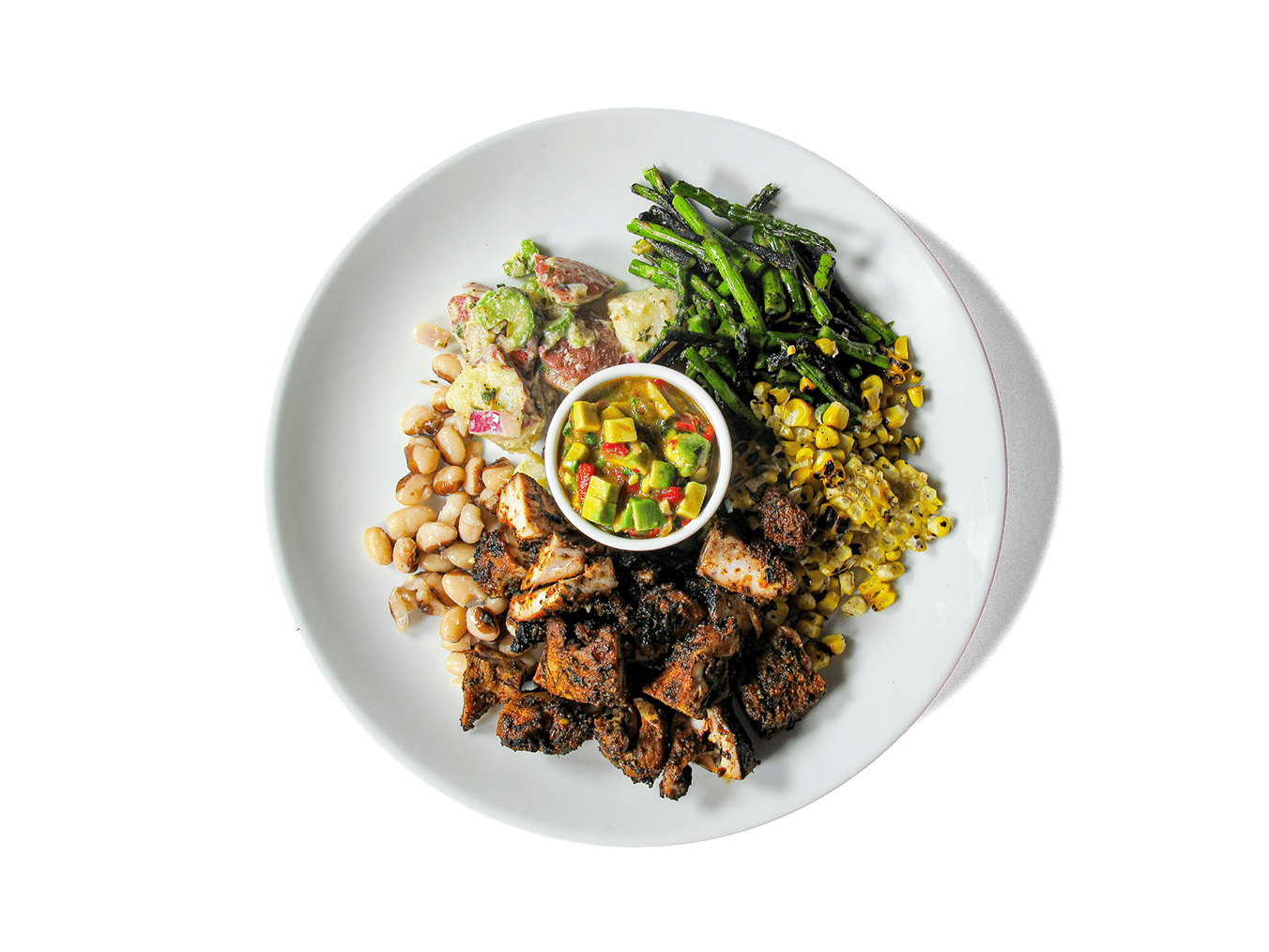Juicy, spice-rubbed chicken thighs charred to perfection, paired with vibrant broccolini, sweet corn, hearty yellow eye beans, and a tangy Dijon red potato salad. Finished with a smoky roasted red pepper and avocado pico de gallo, this protein-rich feast celebrates fresh flavors that nourish and energize.