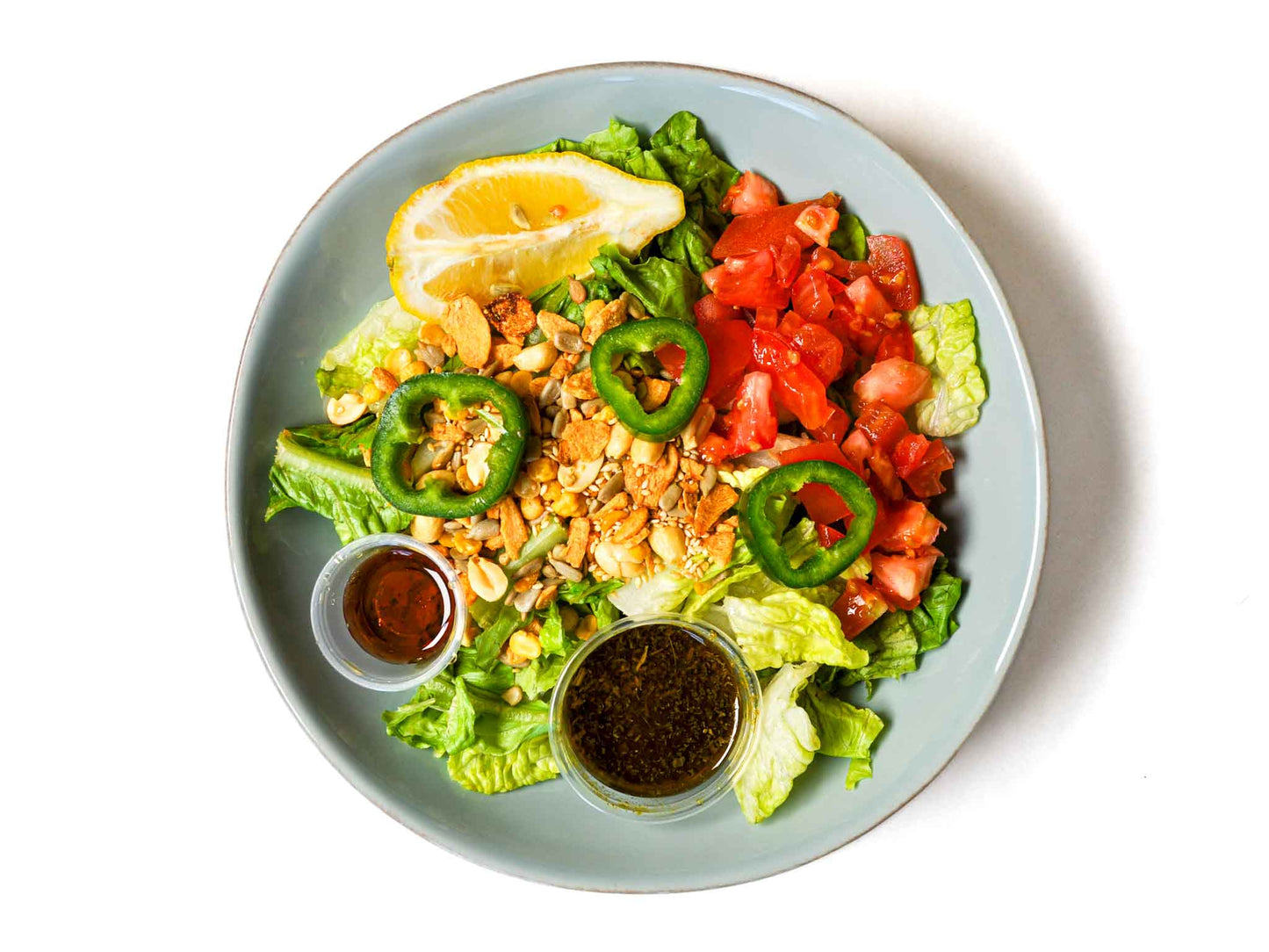 Burma Love's Tea Leaf Salad is a fan favorite! Made with a flavorful mix of crunchy fried garlic, peanuts, sunflower seeds, and roasted sesame. With a hint of sweetness and acidity from fresh lemon and tomatoes. Perfect as a light meal or side dish.