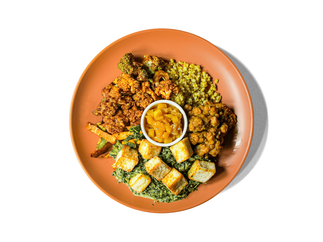 Creamy spinach (saag) simmered with fragrant spices embraces avocado oil-fried cubes cubes of paneer for a comforting, protein-rich centerpiece. It’s paired with hearty chana dal, spice-roasted vegetables, vibrant turmeric rice, and sweet-tangy mango chutney. Bursting with plant-powered protein, fiber, and anti-inflammatory spices, this colorful dish satisfies both taste and well-being.