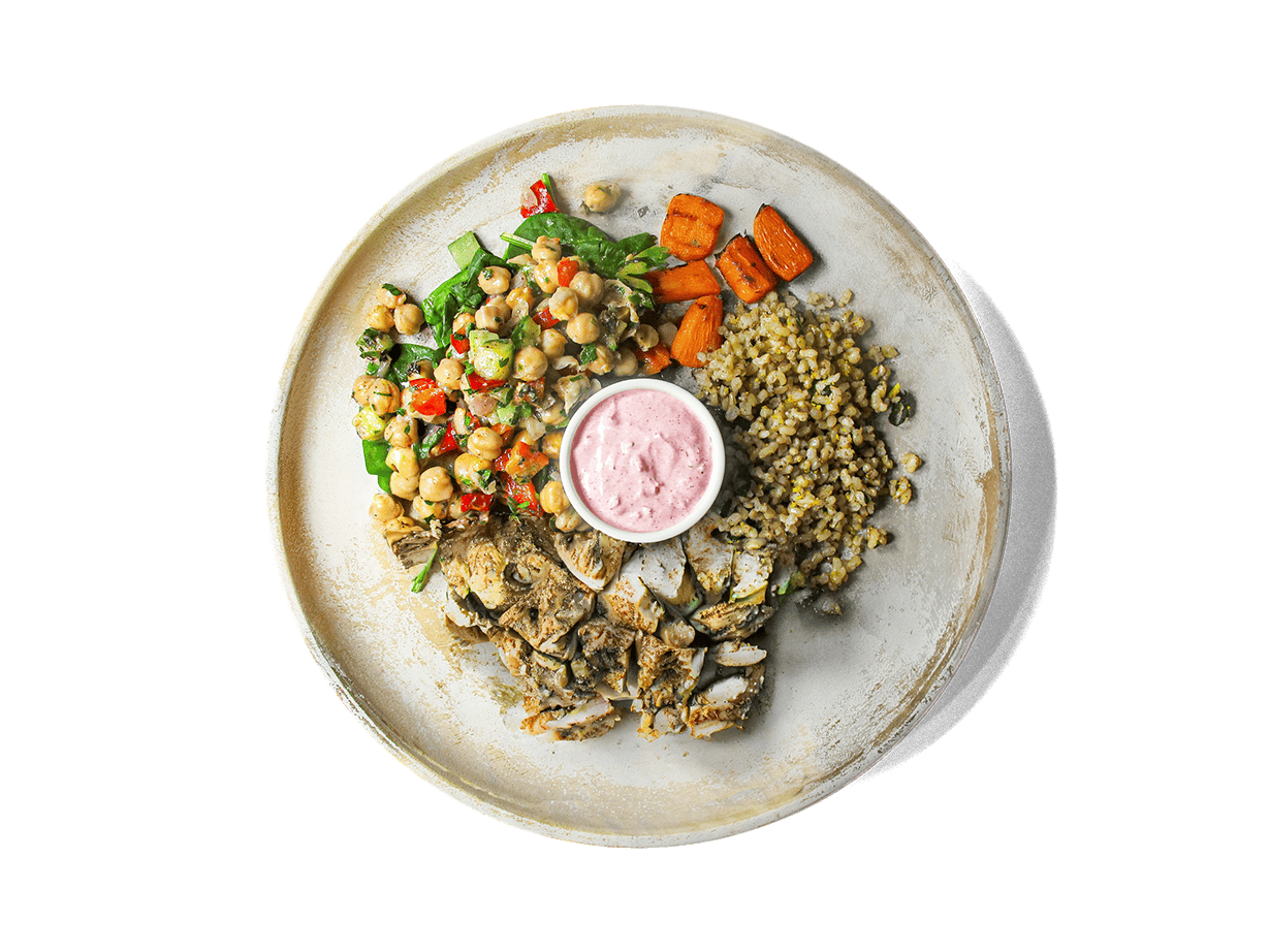 Tender grilled chicken thighs seasoned with sumac, cumin, and lemon rest over aromatic basmati brown rice with orange and basil. Served alongside roasted sumac carrots, zesty chickpea salad, and a swirl of vibrant pink labneh, this bowl bursts with Mediterranean flavors and delivers protein, fiber, and antioxidants to fuel longevity and well-being.