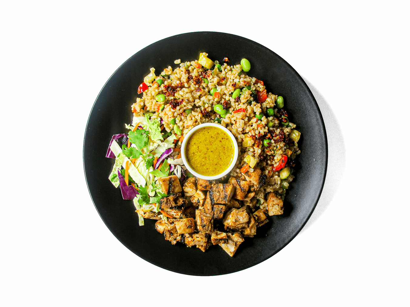 A bold and satisfying dish featuring blackened chicken thigh, wok-tossed brown rice with vibrant vegetables, and a fiery kick from house-made chili crisp and fried rice sauce. Topped with creamy Japanese-style soft scrambled eggs and sweet sesame snap peas, this high-protein, nutrient-packed bowl fuels energy and supports recovery.