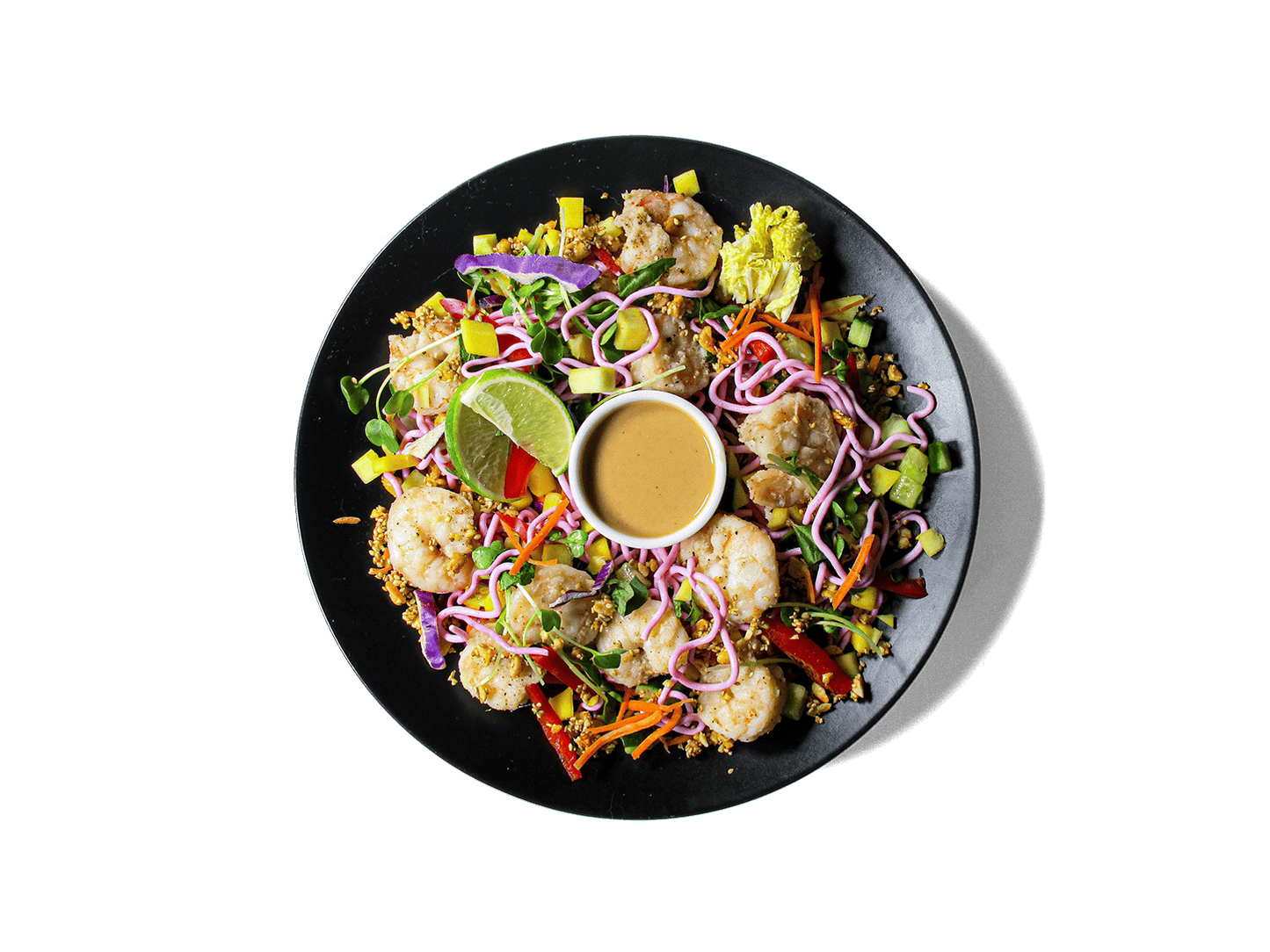 A vibrant, protein-packed bowl featuring shrimp, beet-dyed egg white noodles, and a rainbow of crisp veggies like mango, cabbage, bell pepper, and sprouts. Finished with fresh herbs, tangy lime, and a creamy, house-made cashew dressing. Light, refreshing, and rich in antioxidants—perfect for longevity and clean energy.