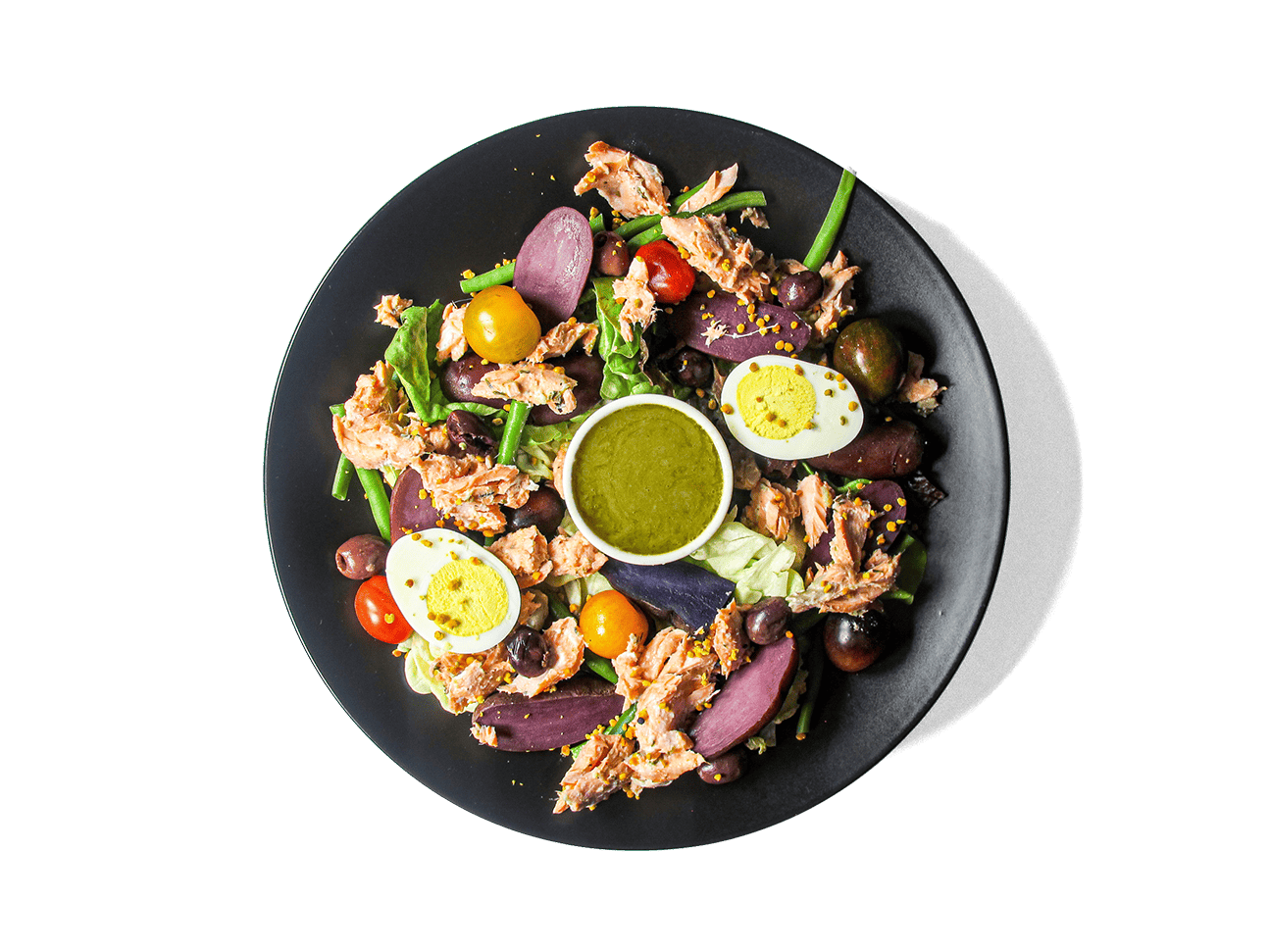 Wild King Salmon Niçoise — tender, Dijon-marinated wild king salmon paired with baby purple fingerling potatoes, crisp haricots verts, heirloom tomatoes, and farm-fresh greens, finished with lemon-caper vinaigrette. Bursting with omega-3s, antioxidants, and vibrant flavor, it’s a nourishing, protein-rich spin on a French classic.