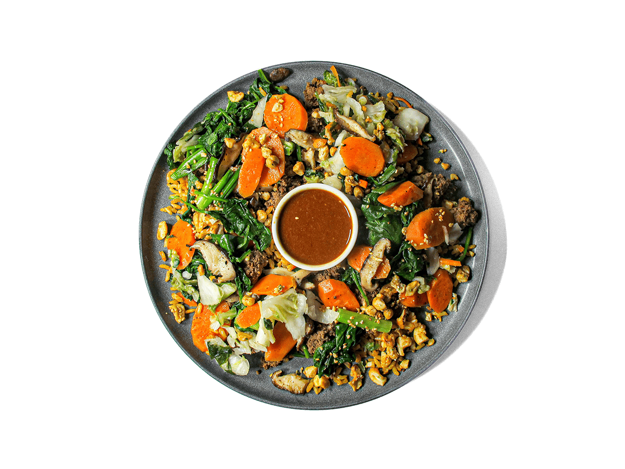 A bold, high-protein bowl featuring savory-sweet ground beef bulgogi over bone broth brown basmati rice, layered with steamed spinach, crisp cucumbers, and lightly pickled kimchi. Finished with a chili garlic sauce kick, a soft-cooked egg, and a cashew sesame crunch for texture. Packed with antioxidants, healthy fats, and gut-friendly ferments—crafted for flavor and longevity.