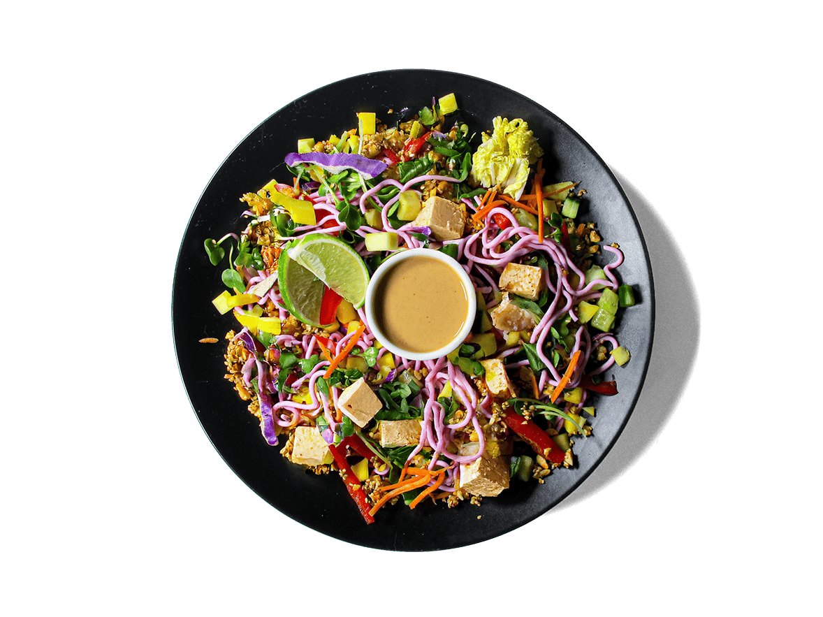 A fresh, vibrant bowl that layers tender tofu, juicy mango, crisp veggies, and beet-dyed egg white noodles. Tossed with a creamy, zesty cashew dressing and topped with herbs and spiced peanuts, it’s packed with plant protein, antioxidants, and healthy fats—crafted to nourish and energize for longevity.
