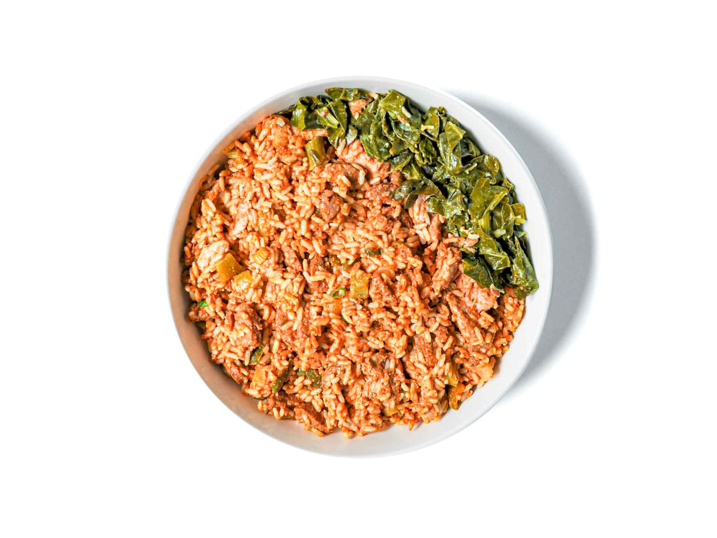 Brenda's French Soul Food's Jambalaya is a vibrant Creole classic featuring smoky sausage, perfectly cooked rice, and a medley of spices. Paired with a side of tender collard greens, this dish offers a hearty, flavorful experience that's steeped in New Orleans tradition.