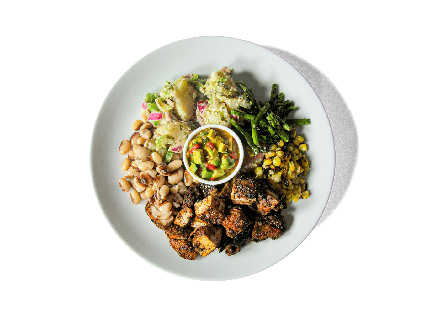 Juicy, spice-rubbed chicken thighs charred to perfection, paired with vibrant broccolini, sweet corn, hearty yellow eye beans, and a tangy Dijon red potato salad. Finished with a smoky roasted red pepper and avocado pico de gallo, this protein-rich feast celebrates fresh flavors that nourish and energize.