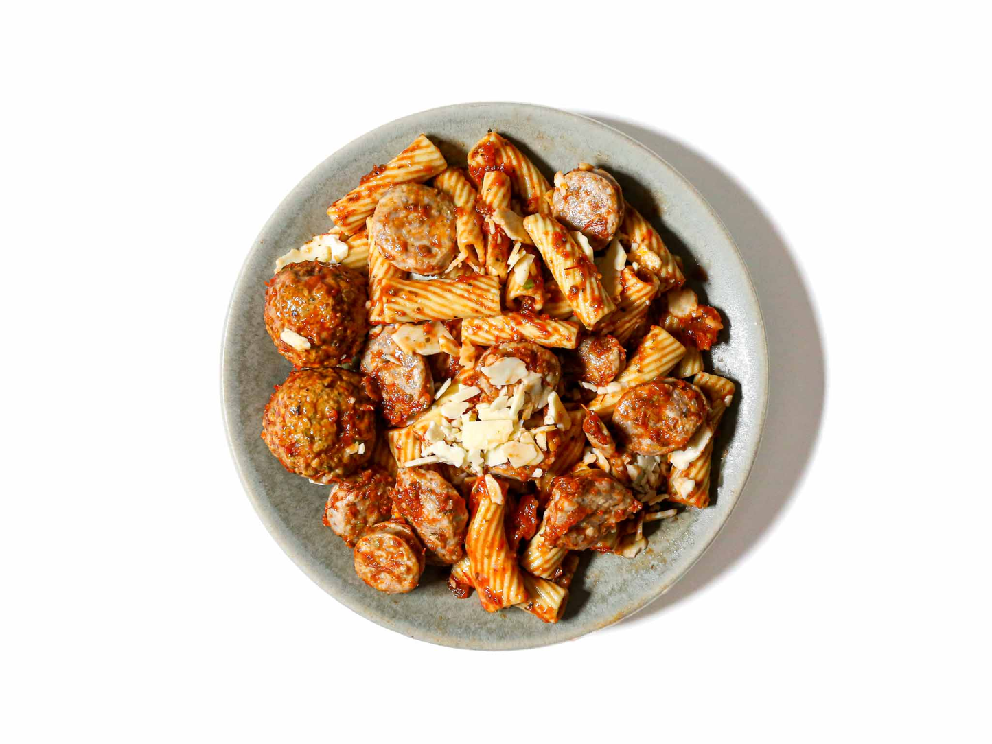 Indulge in the comforting nostalgia of Mom's Sunday Sauce Rigatoni, featuring hearty Fennel Sausage and succulent Meatballs. The slow-cooked sauce imparts rich flavors, coating each rigatoni with a taste of home. A wholesome and satisfying dish that brings the warmth of a Sunday family gathering to every forkful.