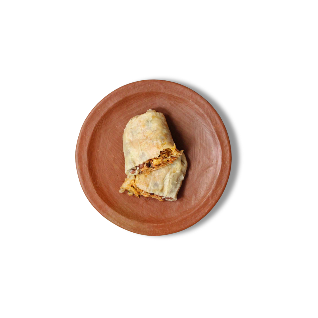Comal's Achiote Grilled Chicken Burrito features juicy chicken, red rice, pinquito beans, and cheese wrapped in a warm flour tortilla. Their addition of chipotle salsa, crema, onion, and cilantro adds freshness and mild spice.