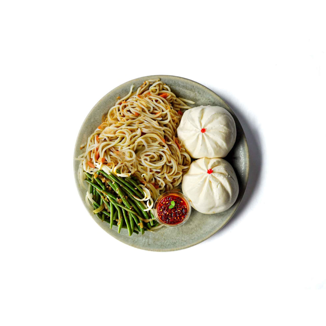 Koi Palace's Chicken and Mushroom Sesame Buns feature soft, fluffy buns filled with a savory mixture of tender chicken and mushrooms, topped with a sprinkle of sesame seeds. This dish offers a harmonious blend of rich flavors and a delightful, pillowy texture.