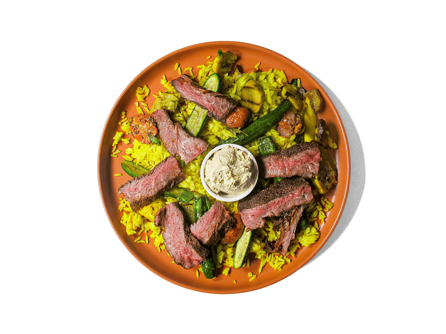 Tender, spice-marinated flat iron steak, slow-cooked to perfection, served with fragrant turmeric-infused jasmine rice. A medley of roasted organic vegetables add depth and nutrition, while a harissa yogurt dressing brings a tangy contrast. A protein-rich, antioxidant-packed meal designed for both flavor and longevity.