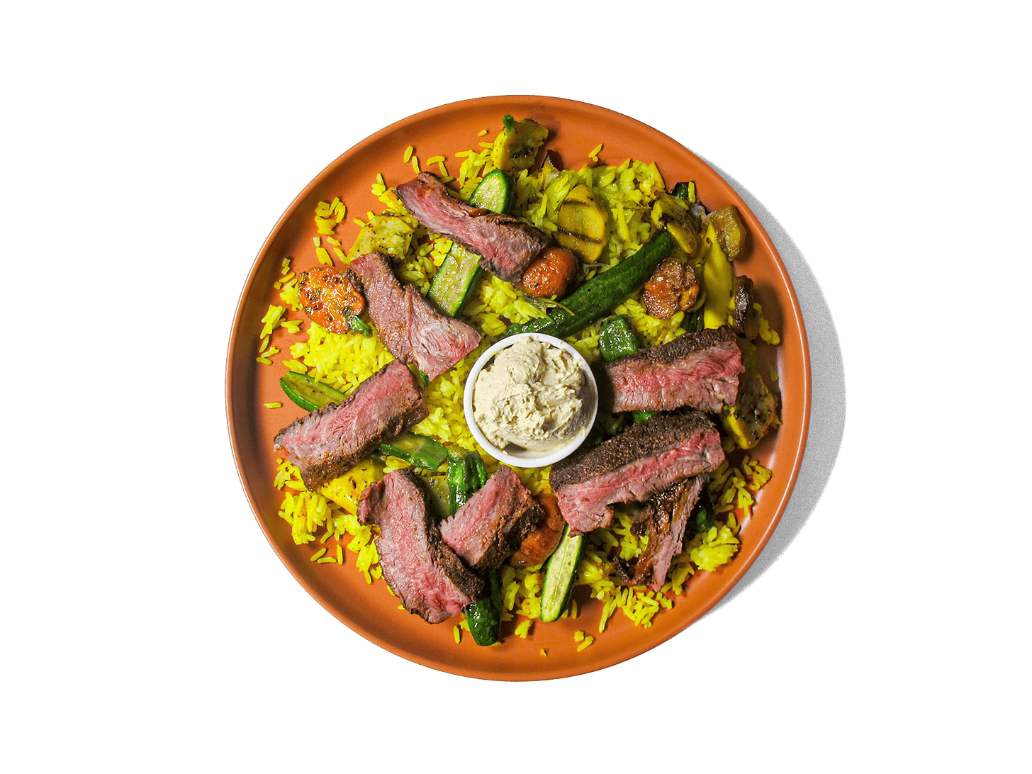 Tender, spice-marinated flat iron steak, slow-cooked to perfection, served with fragrant turmeric-infused jasmine rice. A medley of roasted organic vegetables add depth and nutrition, while a harissa yogurt dressing brings a tangy contrast. A protein-rich, antioxidant-packed meal designed for both flavor and longevity.