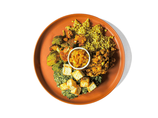 Creamy spinach (saag) simmered with fragrant spices embraces avocado oil-fried cubes of paneer for a comforting, protein-rich centerpiece. It’s paired with hearty chana dal, spice-roasted vegetables, vibrant turmeric rice, and sweet-tangy mango chutney. Bursting with plant-powered protein, fiber, and anti-inflammatory spices, this colorful dish satisfies both taste and well-being.