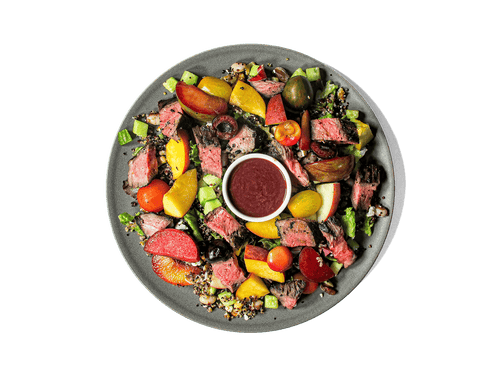 Juicy skirt steak, marinated in dark balsamic and fresh herbs, is grilled to perfection and served over a vibrant quinoa pilaf tossed with yellow-eyed beans, gorgonzola, and toasted walnuts. Sweet peaches, nectarines, plums, cherries, crisp cucumbers, and heirloom tomatoes add fresh bursts of summer flavor, while a cherry balsamic vinaigrette ties it all together. High in protein and antioxidants, this colorful dish nourishes body and palate alike.