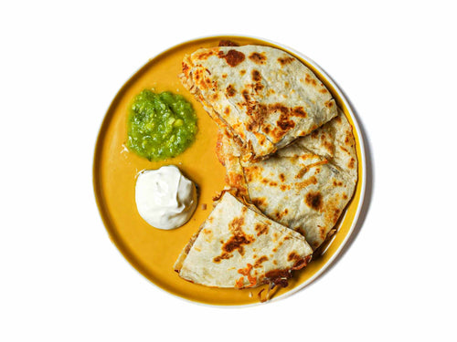 Indulge in the savory delight of El Farolito's Carnitas Quesadilla, featuring tender carnitas folded into a warm tortilla alongside melted cheese. Served with creamy sour cream and zesty salsa on the side, this quesadilla promises to satisfy your cravings for Mexican comfort food.