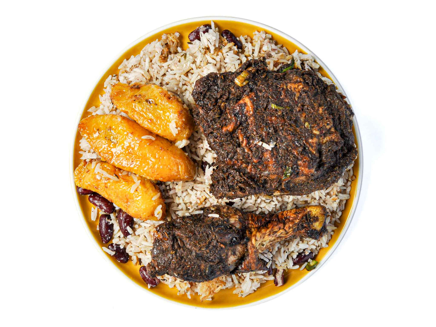 Transport your taste buds to the shores of Jamaica with Jamaican Jerk Chicken, served with fried plantains and fragrant jasmine rice from Peaches Patties. Tender chicken thigh (dark meat), marinated in a fiery blend of Caribbean spices and herbs, is grilled to perfection, offering a burst of bold flavors with every bite. Accompanied by sweet and caramelized fried plantains and fluffy jasmine rice, this dish promises a delightful fusion of savory, sweet, and aromatic notes that will tantalize your senses.