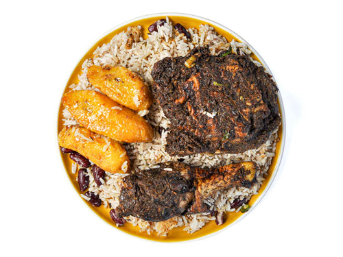 Transport your taste buds to the shores of Jamaica with Jamaican Jerk Chicken, served with fried plantains and fragrant jasmine rice from Peaches Patties. Tender chicken thigh (dark meat), marinated in a fiery blend of Caribbean spices and herbs, is grilled to perfection, offering a burst of bold flavors with every bite. Accompanied by sweet and caramelized fried plantains and fluffy jasmine rice, this dish promises a delightful fusion of savory, sweet, and aromatic notes that will tantalize your senses.
