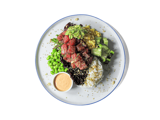 A fresh, protein-rich dish featuring marinated ahi tuna, sushi rice, and purple sushi rice for a vibrant base. Topped with edamame, mango, cucumber, scallions, and sesame seeds, it delivers a perfect balance of sweet, savory, and umami flavors. A crunchy macadamia nut topping adds texture, while a drizzle of sriracha aioli brings a creamy kick. Packed with omega-3s, antioxidants, and essential nutrients, this bowl is both delicious and nourishing.