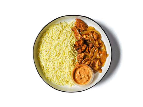 Zareen's Grilled Chicken Boti Thali dish features succulent, charcoal-grilled chicken morsels, marinated in an herb-spice blend for irresistible flavor.