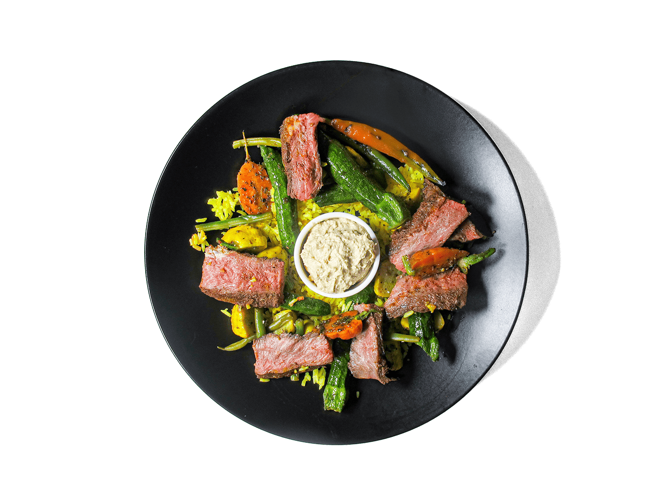 Tender, spice-marinated flat iron steak, slow-cooked to perfection, served with fragrant turmeric-infused jasmine rice. A medley of roasted organic vegetables add depth and nutrition, while a harissa yogurt dressing brings a tangy contrast. A protein-rich, antioxidant-packed meal designed for both flavor and longevity.