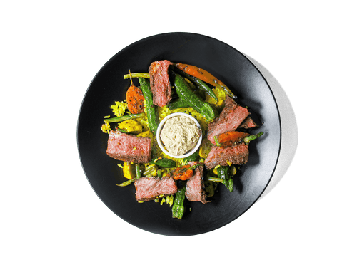 Tender, spice-marinated flat iron steak, slow-cooked to perfection, served with fragrant turmeric-infused jasmine rice. A medley of roasted organic vegetables add depth and nutrition, while a harissa yogurt dressing brings a tangy contrast. A protein-rich, antioxidant-packed meal designed for both flavor and longevity.