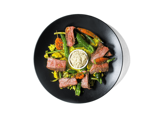 Tender, spice-marinated flat iron steak, slow-cooked to perfection, served with fragrant turmeric-infused jasmine rice. A medley of roasted organic vegetables add depth and nutrition, while a harissa yogurt dressing brings a tangy contrast. A protein-rich, antioxidant-packed meal designed for both flavor and longevity.