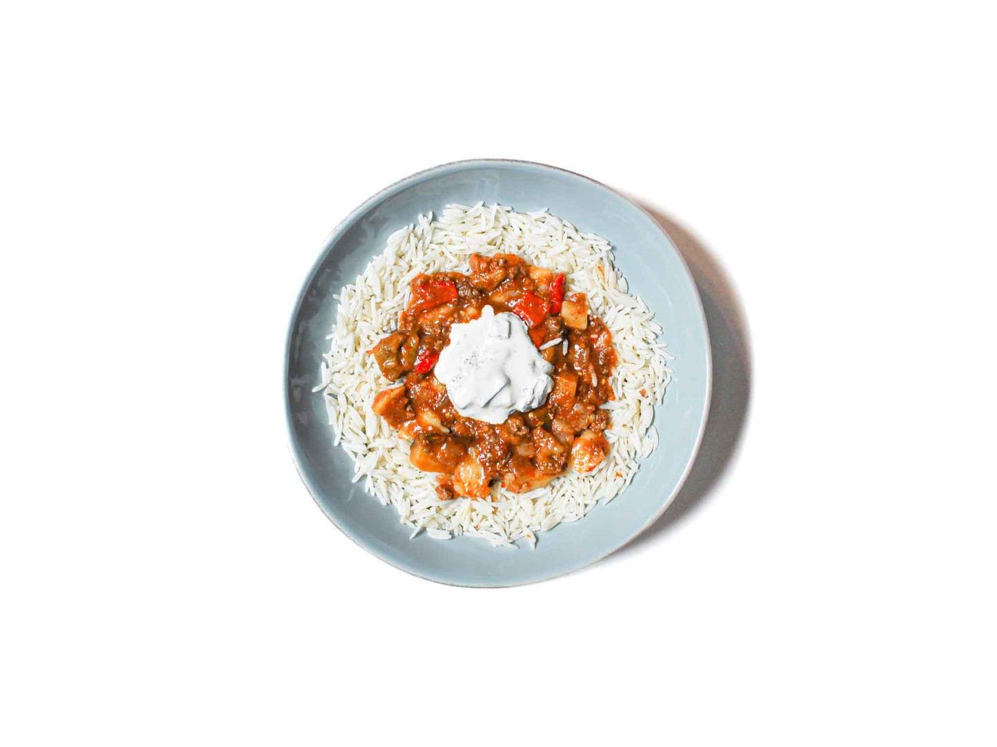 Eggplant Beef Stew from Soupchu features tender chunks of beef and roasted eggplant slow-cooked in a rich, savory broth. Paired with aromatic basmati rice and a refreshing dollop of creamy tzatziki, this dish offers a hearty and flavorful experience with a balance of robust and cooling elements.