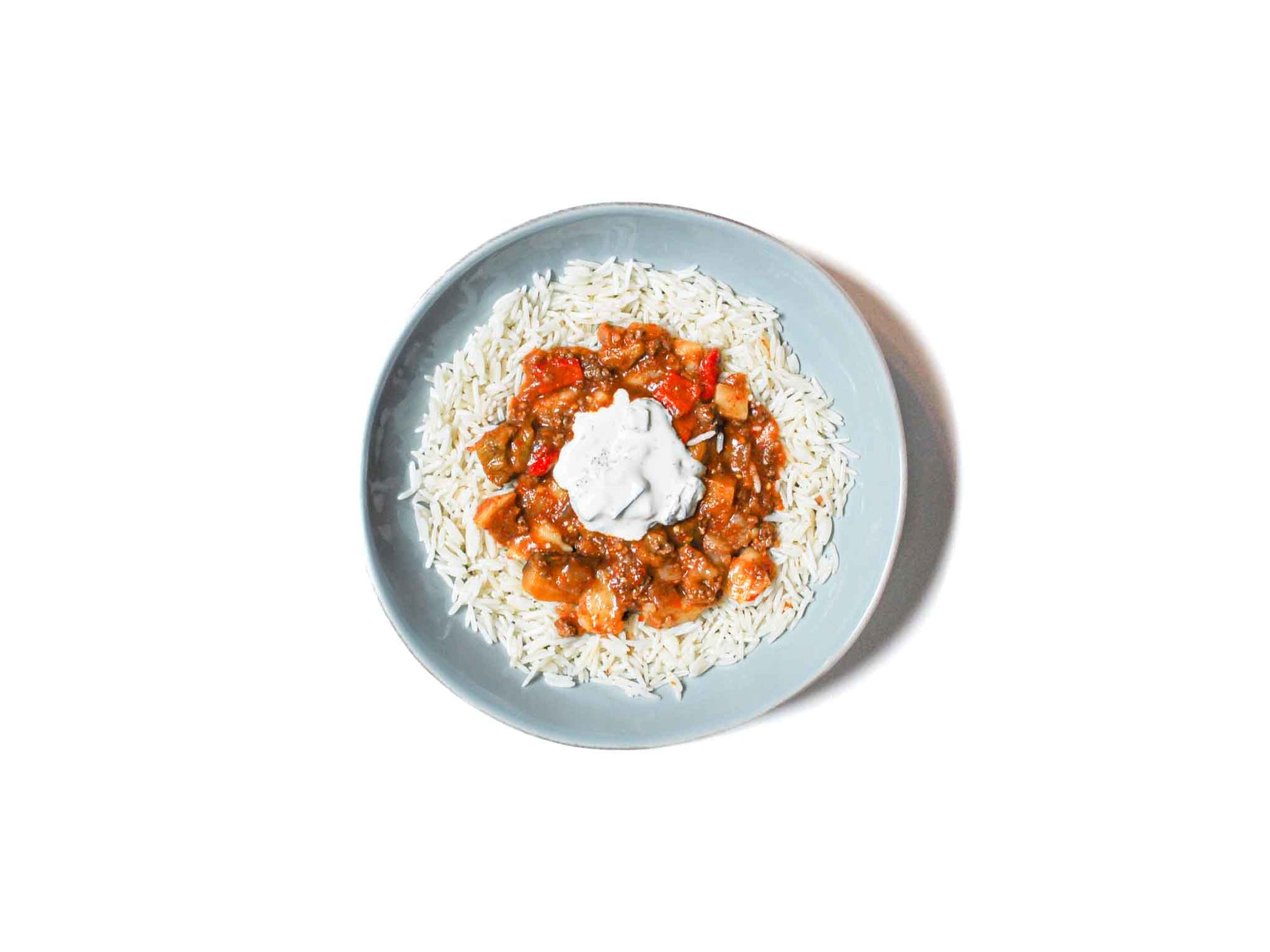 Eggplant Beef Stew from Soupchu features tender chunks of beef and roasted eggplant slow-cooked in a rich, savory broth. Paired with aromatic basmati rice and a refreshing dollop of creamy tzatziki, this dish offers a hearty and flavorful experience with a balance of robust and cooling elements.