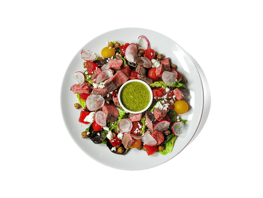 Tender grass-fed flank steak meets juicy compressed watermelon, roasted chickpeas, heirloom tomatoes, and radish, all tossed in a bright cucumber mint vinaigrette. Finished with sheep’s milk feta and crisp greens, this vibrant dish is rich in protein, antioxidants, and heart-healthy fats—designed to fuel strength and longevity.