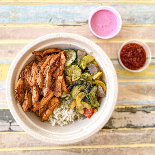 Sumac's Turkish Chicken Bowl features marinated organic chicken thighs, roasted seasonal veggies, and fragrant basmati rice infused with fresh dill. Flavorful and aromatic.