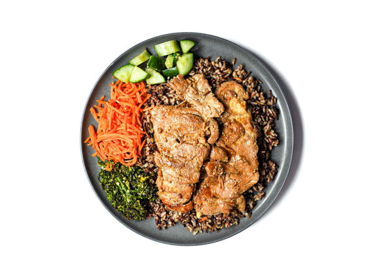 Savor the exquisite flavors of Hawaiian Drive Inn's Chicken Teriyaki and Wild Rice, featuring tender chicken marinated in a savory teriyaki glaze, served alongside hearty wild rice. Accompanied by vibrant broccolini, crisp cucumber slices, and delicate shreds of carrots, this dish offers a delightful balance of savory and fresh flavors. 