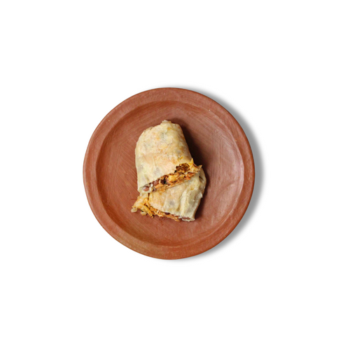 Comal's Achiote Grilled Chicken Burrito features juicy chicken, red rice, pinquito beans, and cheese wrapped in a warm flour tortilla. Their addition of chipotle salsa, crema, onion, and cilantro adds freshness and mild spice. 