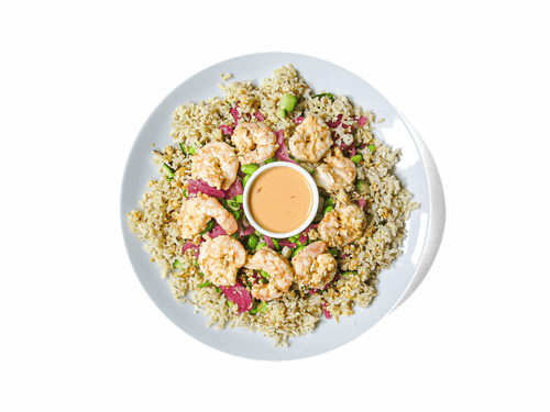 Succulent Bang Bang shrimp, coated in a creamy, spicy sauce, served over coconut-infused jasmine brown rice with crisp edamame, cucumbers, and spinach. Topped with pickled onions, scallions, and a crunchy blend of macadamia, coconut, and sesame for the perfect balance of heat, freshness, and texture. Packed with protein and healthy fats to fuel your body.