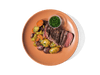 Tender, juicy steak served alongside heirloom marble potatoes. Accompanied by roasted carrots, and a fresh chimichurri, this hearty dish delivers bold flavors and a perfect balance of rich, savory notes and vibrant herbal freshness.
