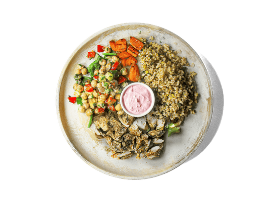 Tender grilled chicken thighs seasoned with sumac, cumin, and lemon rest over aromatic basmati brown rice with orange and basil. Served alongside roasted sumac carrots, zesty chickpea salad, and a swirl of vibrant pink labneh, this bowl bursts with Mediterranean flavors and delivers protein, fiber, and antioxidants to fuel longevity and well-being.