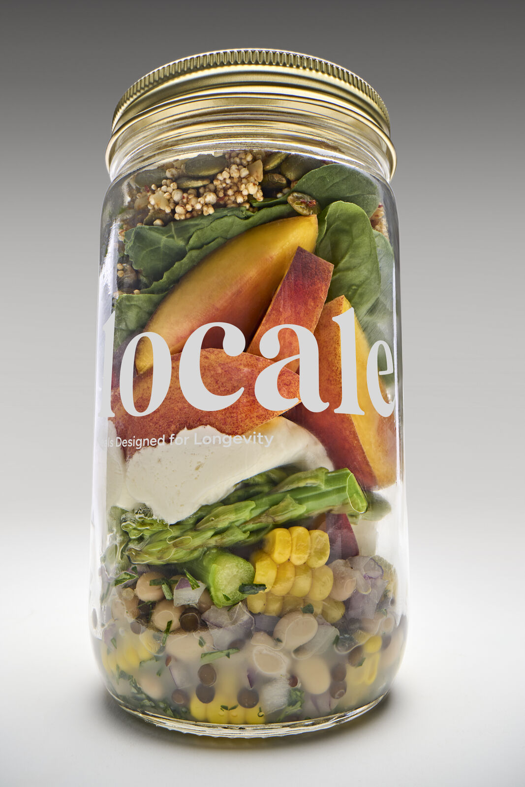 Locale meal jar layered with stone fruit, greens and grains